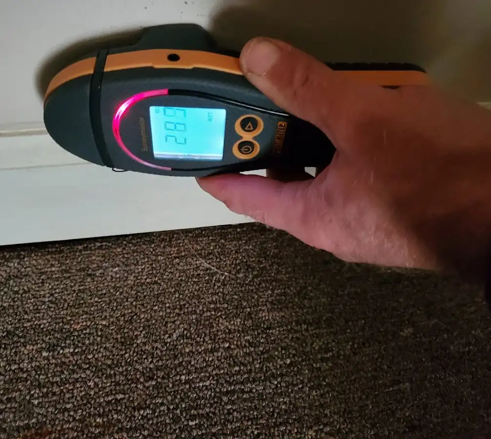 Moisture detection at baseboard during Storm Damage Restoration in Zebulon